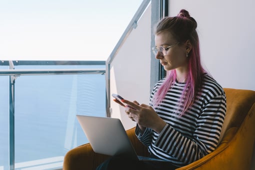 AIOps woman sitting on balcony with laptop