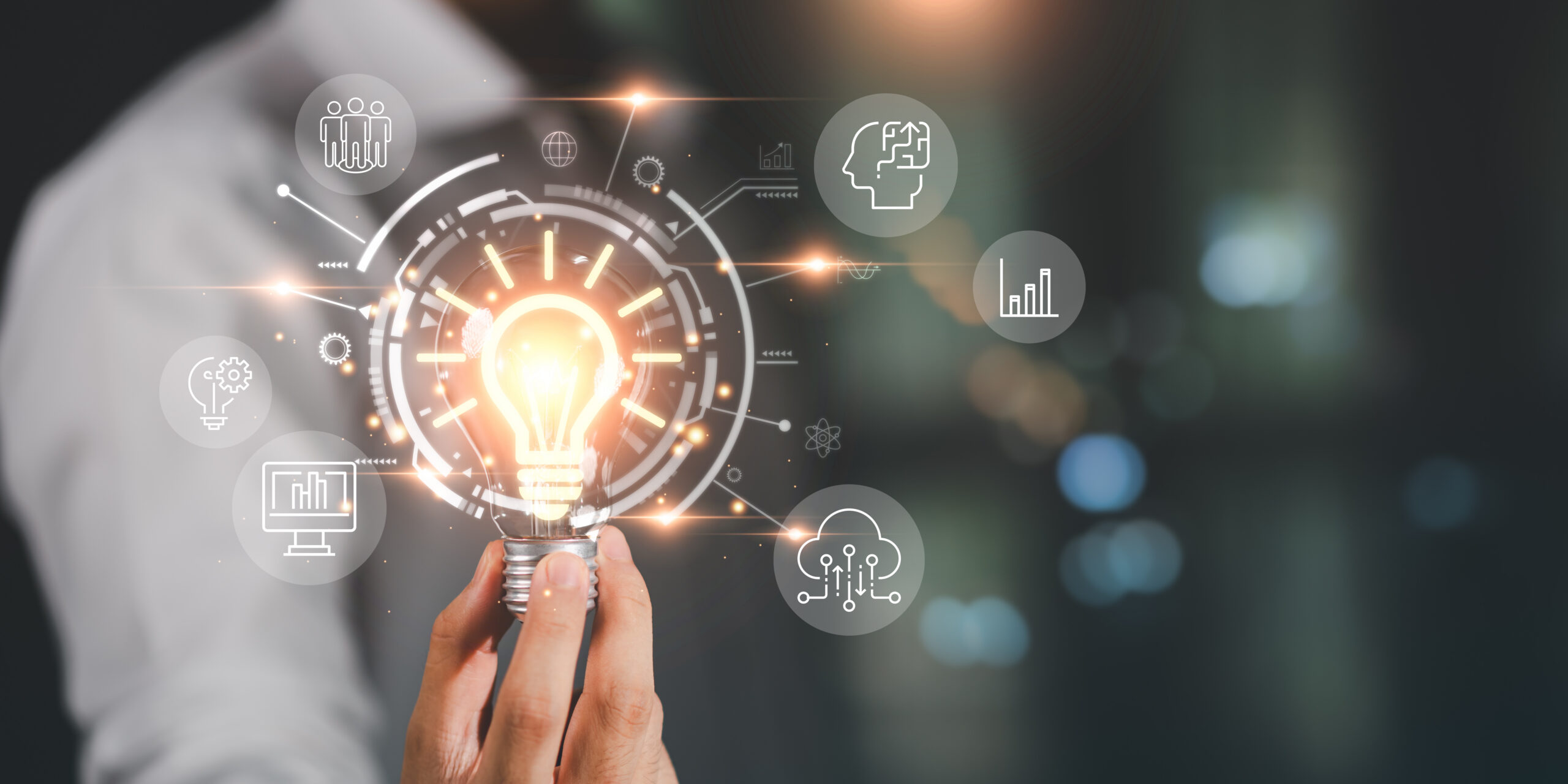 Business professional holding illuminated lightbulb with connected technology and cloud icons representing SAP modernization insights