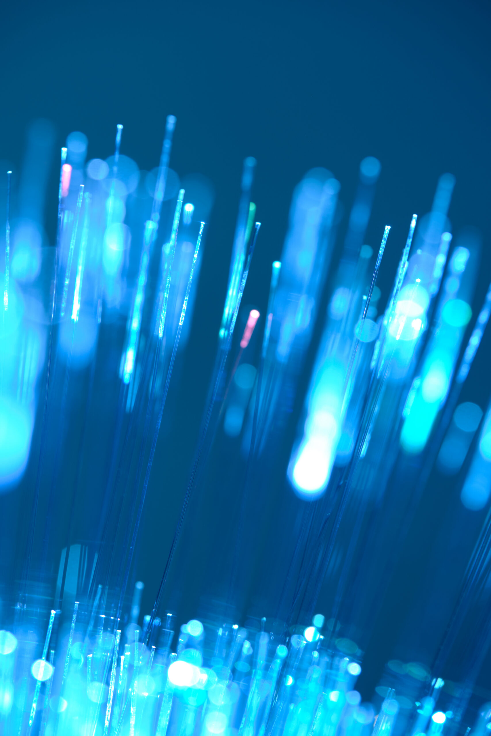 Upward flowing fiber optic light streams in blue representing the forward momentum and operational clarity Avantra delivers throughout SAP S/4HANA migration and hypercare
